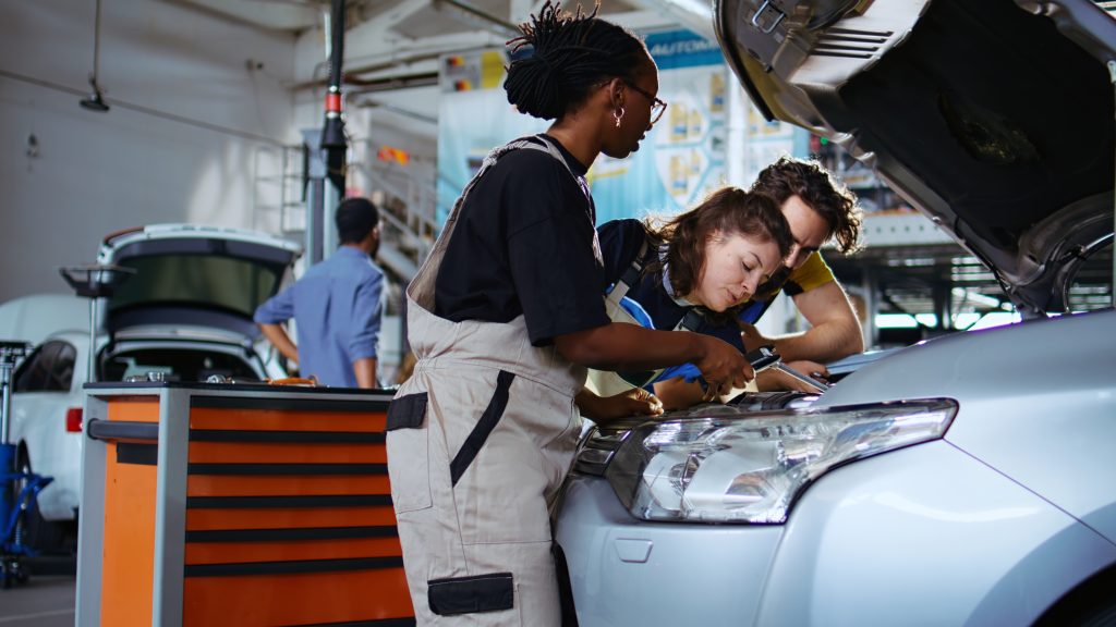 team of mechanics fixing car