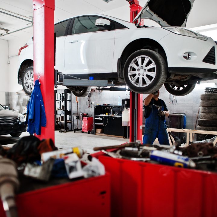 car repair and maintenance theme. mechanic in uniform working in
